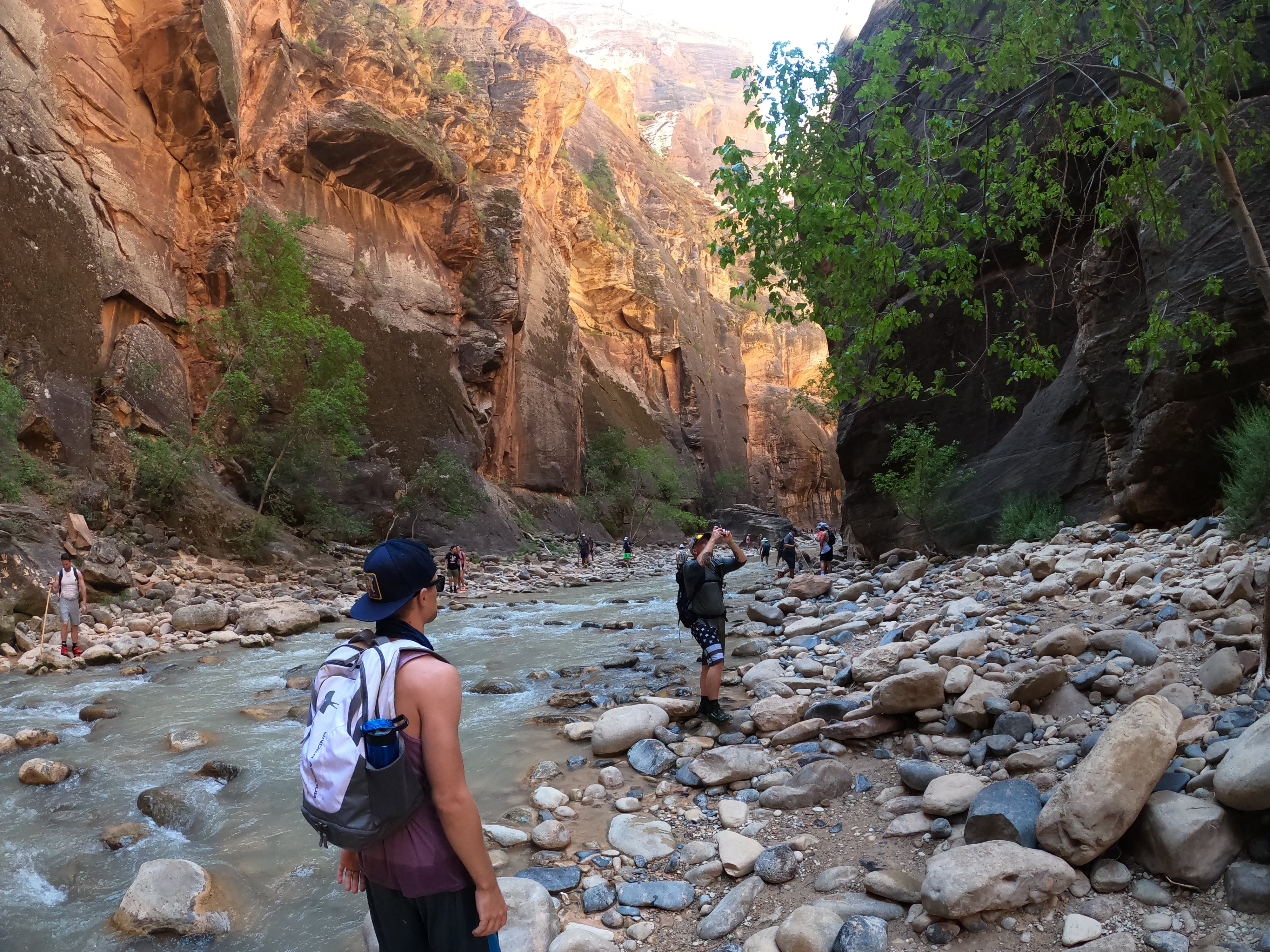 walking in the river taking photo hiking in rocks