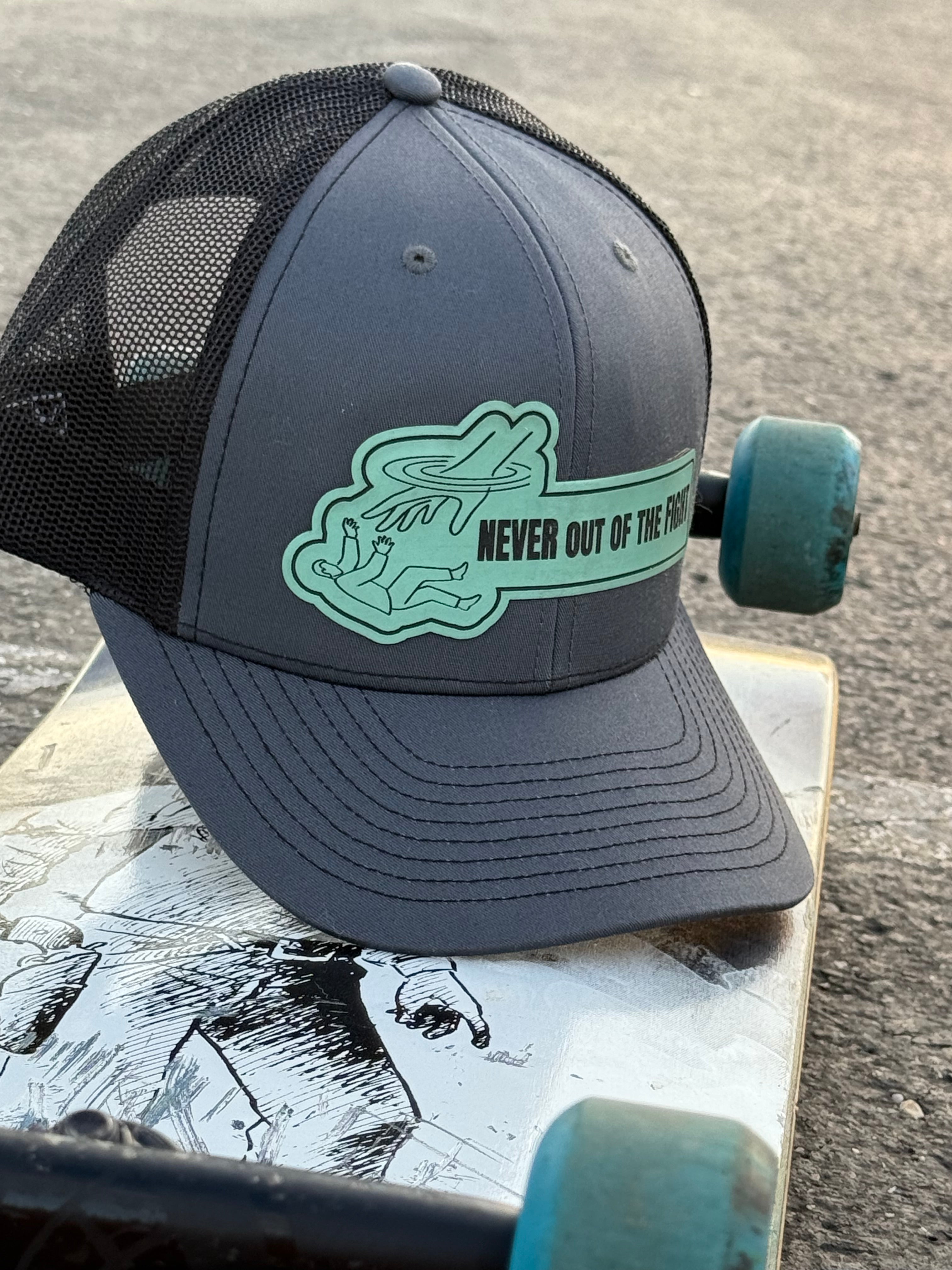 Gray cap with green logo on a skateboard
