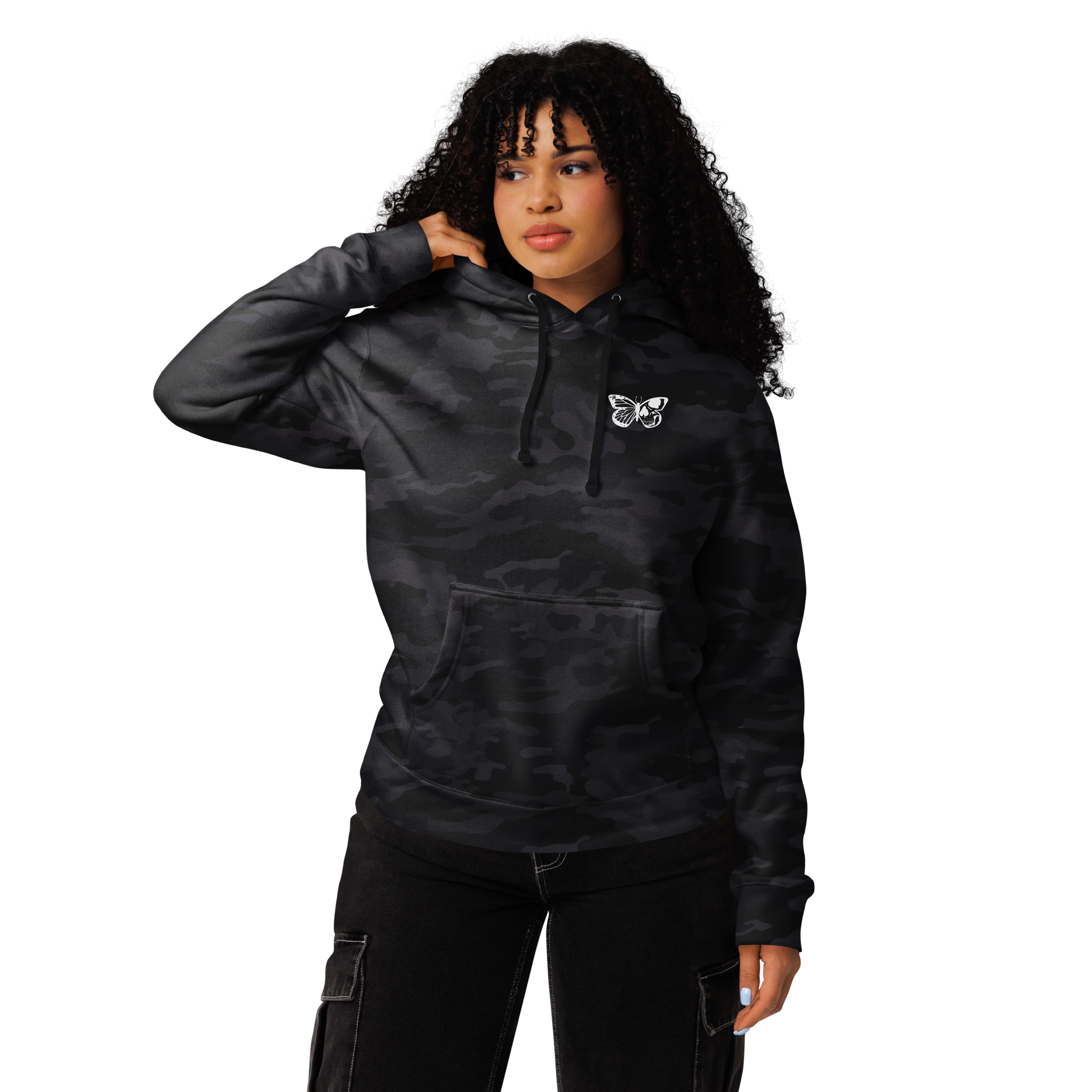 Person wearing a black camouflage hoodie with a small logo on a white background