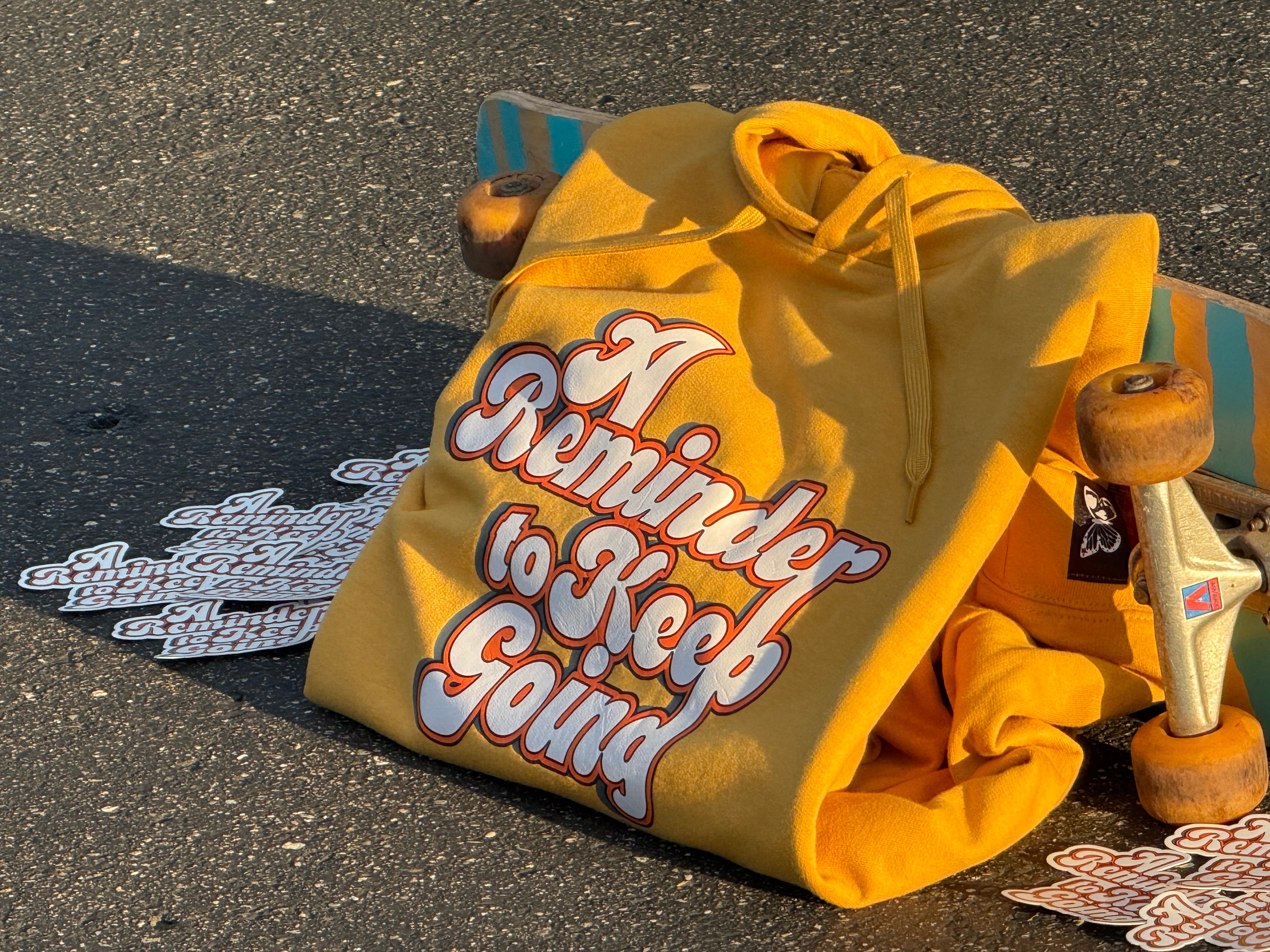 Yellow hoodie with text on a skateboard