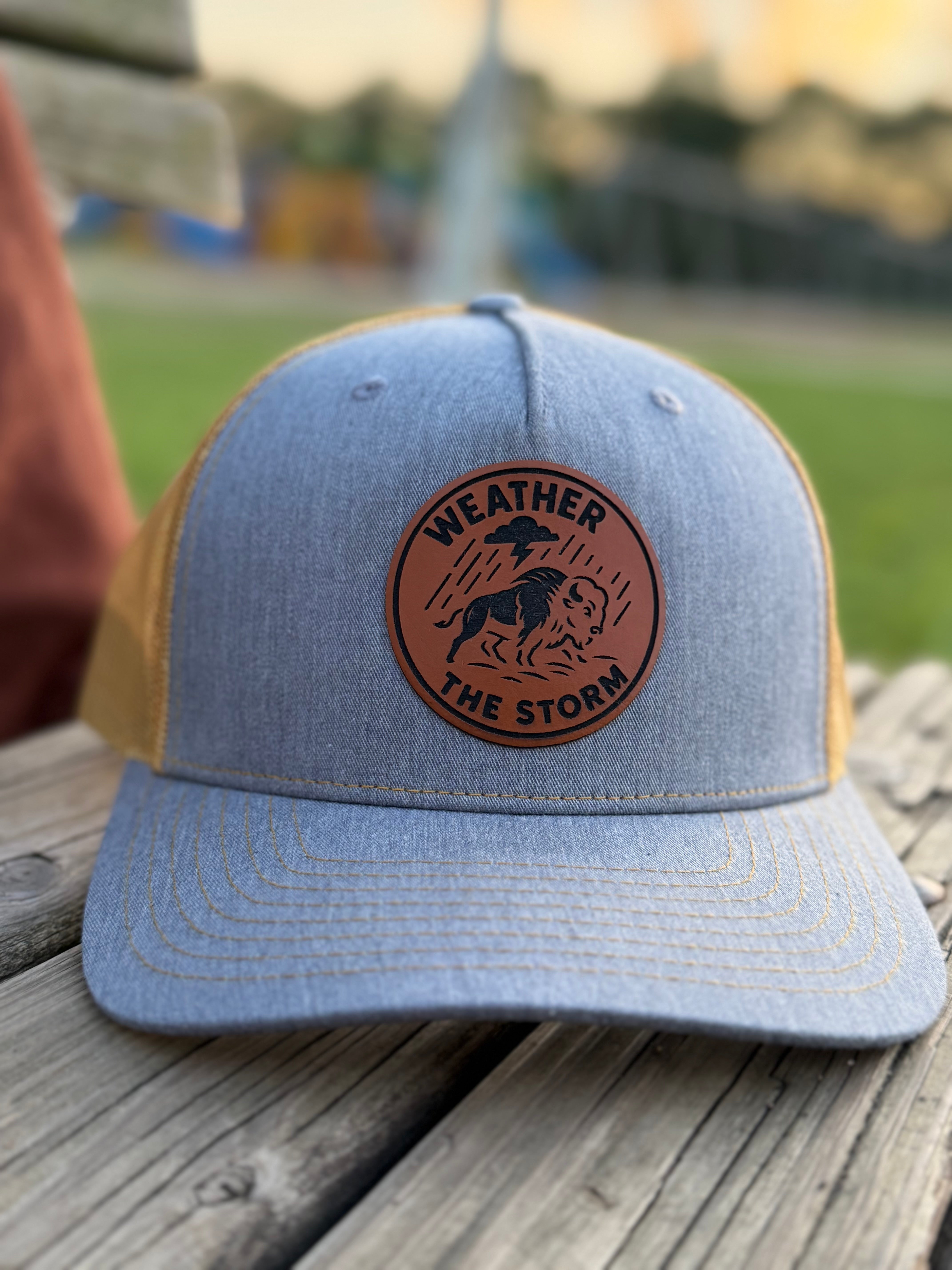 Close-up of engraved Weather the Storm patch on snapback hat