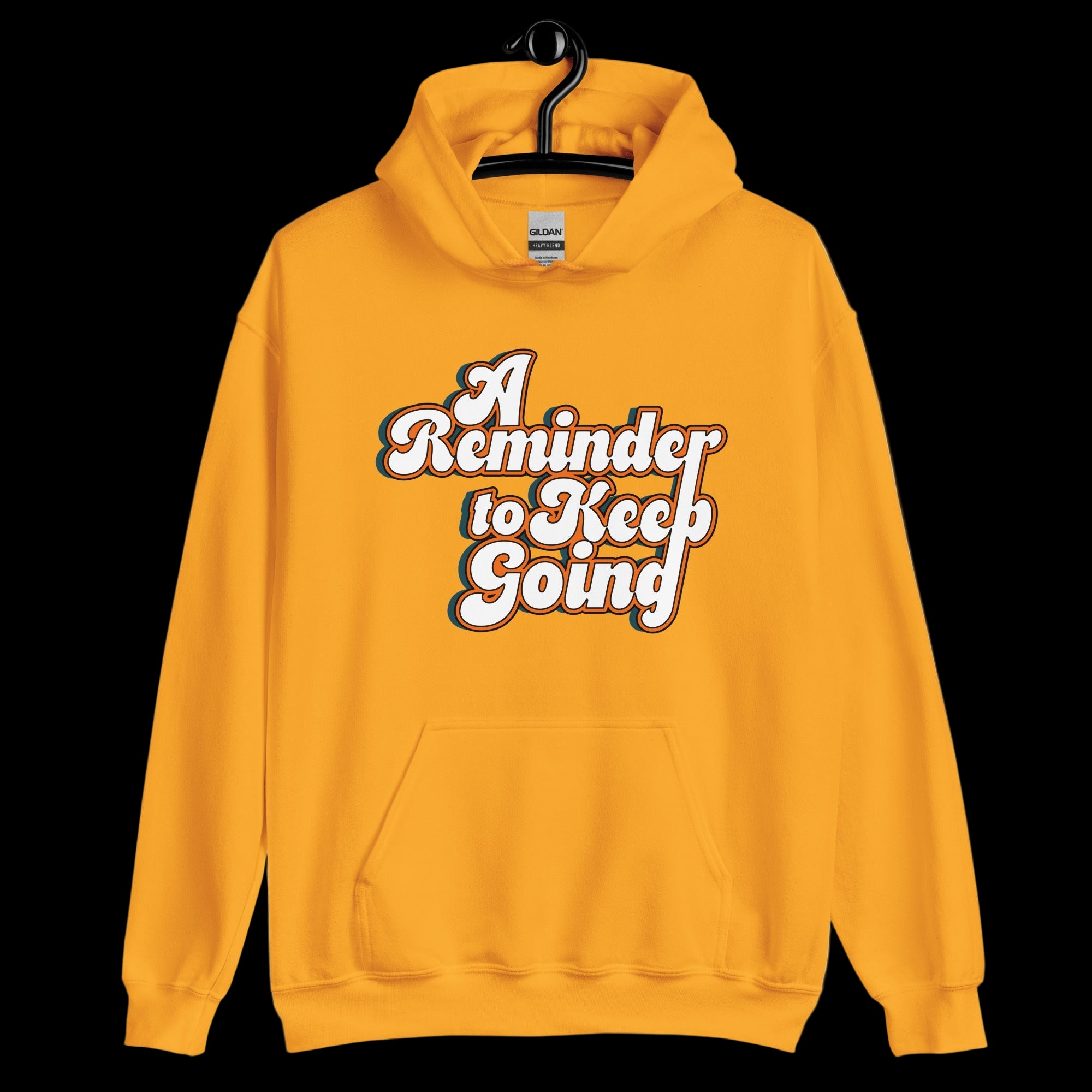 Yellow hoodie with 'A Reminder to Keep Going' text on a white background