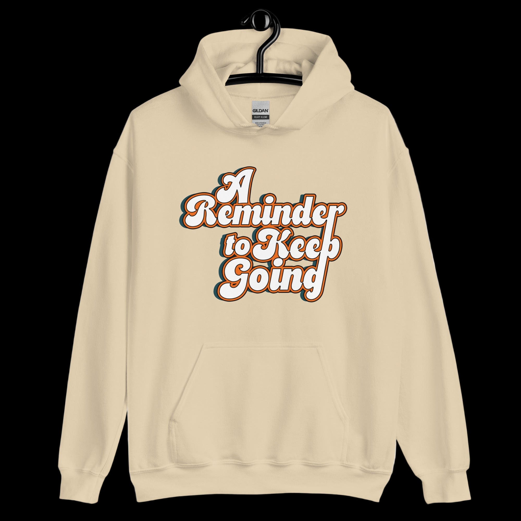 Beige hoodie with 'A Reminder to Keep Going' text on a white background